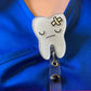 Tooth badge reels for dentists and dental hygienists