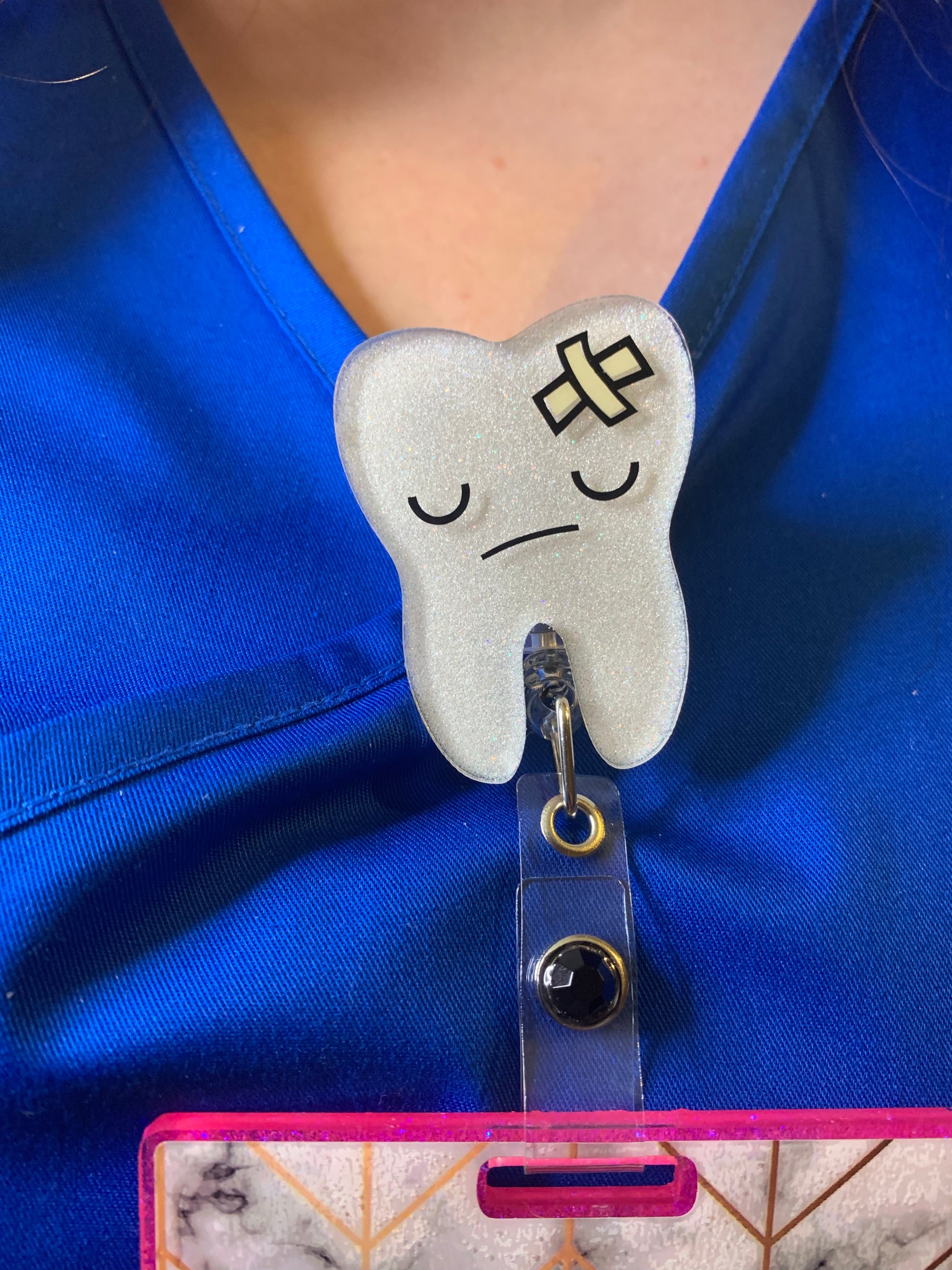 Tooth badge reels for dentists and dental hygienists